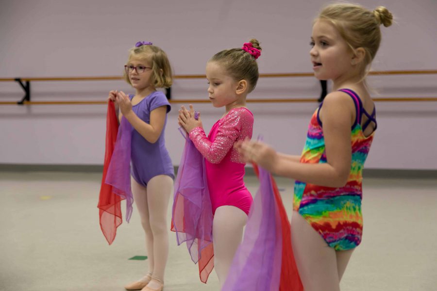 three young female dancers in leotards and tights taking a tiny twos dance class